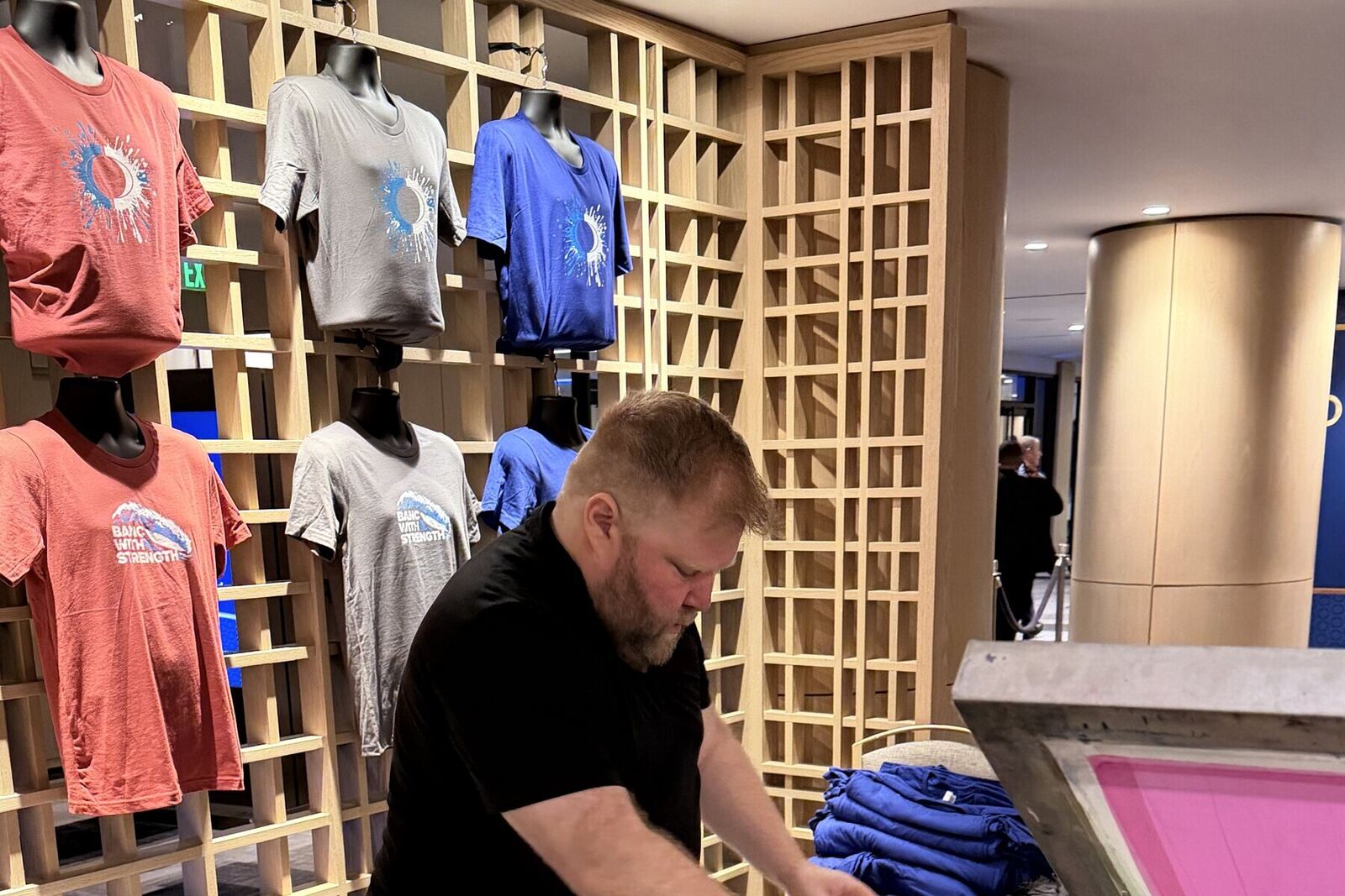 Finished custom shirts displayed at an event