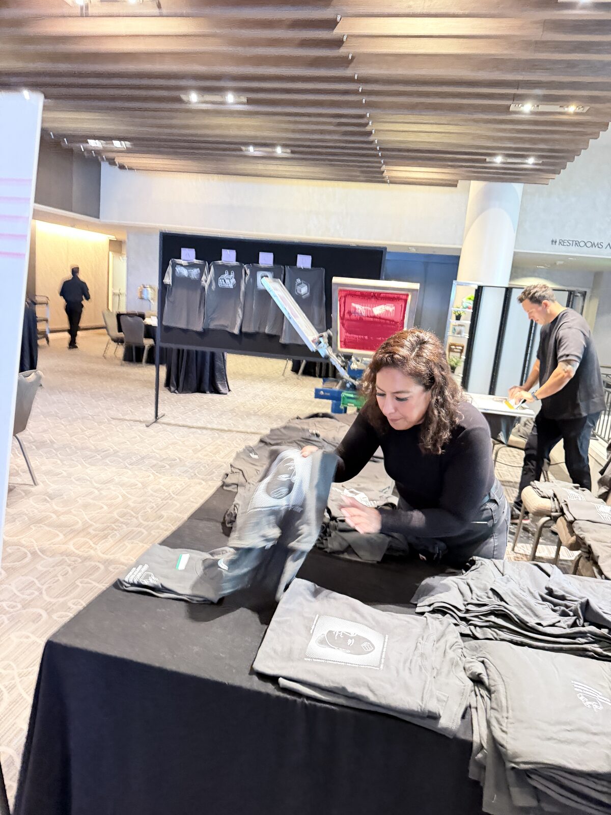 Crew folding fresh custom shirts for guests